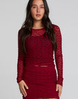 Front view of a woman wearing the Chaser Kevin Deep Berry Longsleeve on a neutral background with matching red skirt