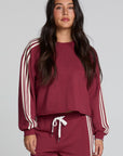 Front view of a woman wearing the Chaser Kloud Burnt Red Sweatshirt on a neutral background with matching red pants