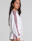 Side view of a woman wearing the Chaser Kloud Cloud White Sweatshirt Set on a neutral background with white shorts