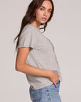 Side view of a woman wearing the Chaser Live Music Graphic Tee and jeans on a neutral background