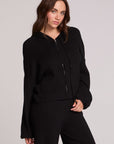 Front view of a woman wearing the Chaser Lizbeth Black Hoodie Jacket and matching black pants on a neutral background