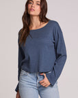 Front view of a woman wearing the Chaser Lunnah Dark Denim Top and blue jeans on a neutral background