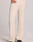Front view of a woman wearing the Chaser Mariya Amtique White Pants on a neutral background with black shoes