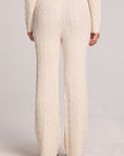 Back view of a woman wearing the Chaser Mariya Amtique White Pants on a neutral background