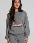 Front view of a woman wearing the Chaser Mini Star Glaze Sweatshirt on a neutral background