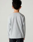 Back view of a boy wearing the Chaser Moto Boys Tee and pants on a neutral background