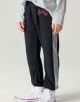 Side angle view of a boy wearing the Chaser Moto Pants Boys Jogger on a neutral background