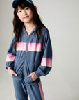 Full body front view of a girl wearing the Chaser Multi Stripes Girls Hoodie on a neutral background with hands in pockets