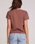 Back view of a woman wearing the Chaser Off Road Race Team Graphic Tee and blue jeans on a neutral background