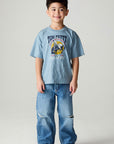 A full body front view of a boy wearing the Chaser Racers Boys Tee on a neutral background