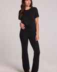 A full body front view of a woman wearing the Chaser Rhose Black Pants on a neutral background