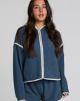 Front view of a woman wearing the Chaser Sharun Dark Denim Jacket on a neutral background