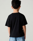 Back view of a boy wearing the Chaser Spooky Friends Boys Tee on a neutral background with jeans