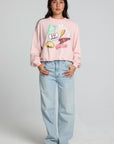 A full body front view of a woman wearing the Chaser Sporty Patches Long Sleeve Top on a neutral background