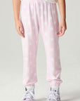 Front view of a girl wearing the Chaser Stars Allover Girls Jogger on a neutral background with arms lowered