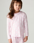 Front view of a girl wearing the Chaser Stars Allover Girls Tee on a neutral background with matching long sleeve top
