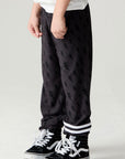 Side view of a boy wearing the Chaser Storm Boys Jogger on a neutral background