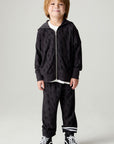 Full body front view of a boy wearing the Chaser Storm Boys Jogger on a neutral background with a matching sweatshirt