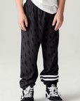 Front view of a boy wearing the Chaser Storm Boys Jogger on a neutral background with a white tee