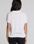 Back view of a woman wearing the Chaser Sun Records Elvis 1972 Tee on a neutral background with arms at sides