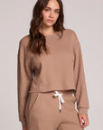 Front view of a woman wearing the Chaser Suzzans Camel Cropped Sweatshirt and matching pants on a neutral background
