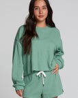 Front view of a woman wearing the Chaser Suzzans Verdelle Sweatshirt on a neutral background