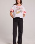 A full body front view of a woman wearing the Chaser Teddy Tee on a neutral background