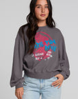 Front view of a woman wearing the Chaser The Paris Punk Graphic Sweatshirt on a neutral background