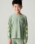 Front view of a boy wearing the Chaser Touchdown Boys Tee on a neutral background with matching long-sleeve shirt