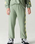 Front view of a boy wearing the Chaser Touchdown Pants Boys Jogger on a neutral background and long-sleeve shirt