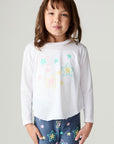 Front view of a girl wearing the Chaser Under The Stars Girls Tee on a neutral background with star pants