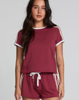 Front view of a woman wearing the Chaser Urban Burnt Red Tee on a neutral background with matching shorts