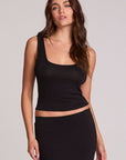 Front view of a woman wearing the Chaser Verze Black Top on a neutral background with matching black skirt