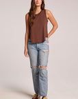 Front view of a woman wearing the Chaser Flouncy Kahlua Muscle Tank and sneakers on a neutral background
