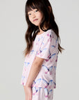 Side view of a girl wearing the Chaser Flutter Butterfly Tee on a neutral background