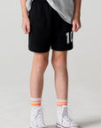 Front view of a boy wearing the Chaser Go Team Shorts on a neutral background