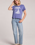 Full body front view of a woman wearing the Chaser Good Times Sailing Club Tee and sneakers on a neutral background