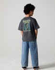 Full body back view of a boy wearing the Chaser Grateful Dead Tour Tee on a neutral background