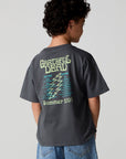 Back view of a boy wearing the Chaser Grateful Dead Tour Tee on a neutral background