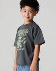 Side angle view of a boy wearing the Chaser Grateful Dead Tour Tee on a neutral background