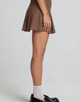 Side view of a woman wearing the Chaser Ivy Choco Check Skort on a neutral background with black shoes