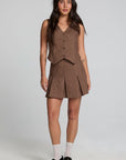 A full body front view of a woman wearing the Chaser Ivy Choco Check Skort on a neutral background