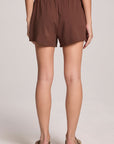 A back view of a woman wearing the Chaser Kahlua Harper Shorts on a neutral background