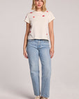 Full body front view of a woman wearing the Chaser Lips Embroidery Tee and sneakers on a neutral background