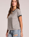 Side angle view of a woman wearing the Chaser Rambler Streaky Grey and Pine Tee on a neutral background with arms at her sides