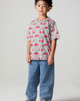 Full body front view of a boy wearing the Chaser Sneaks and Headphones Tee on a neutral background