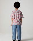 Full body back view of a boy wearing the Chaser Sneaks and Headphones Tee on a neutral background