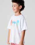 Side angle view of a boy wearing the Chaser Sunglass Pop Tee on a neutral background