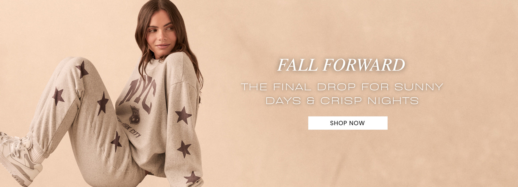 A Chaser model wearing the New York Stars Pullover and matching star-print bottoms, posed against a clean beige backdrop—styled for cozy, coordinated fall layering.