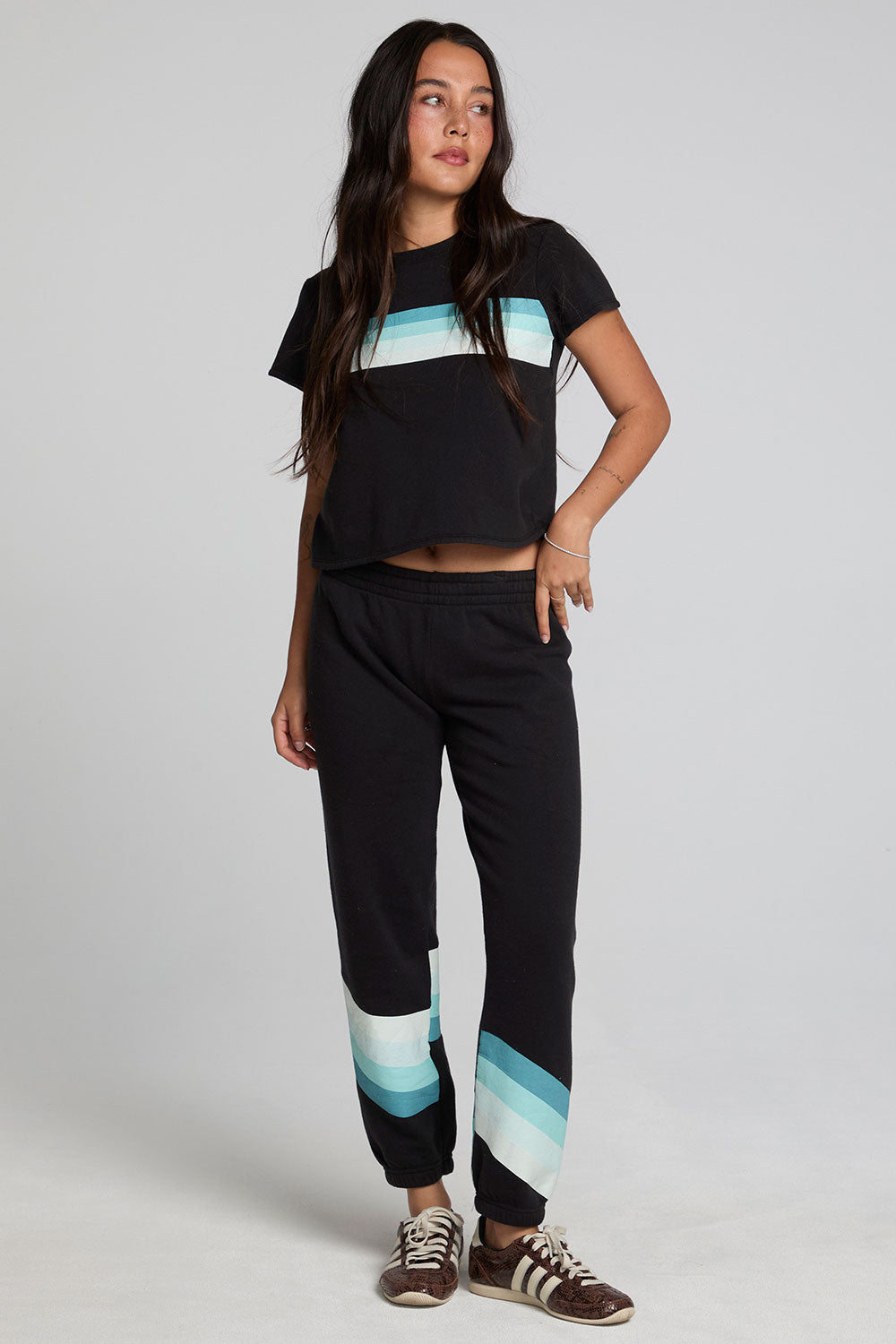 A full body front view of a woman wearing the Chaser Ada Black Jogger on a neutral background
